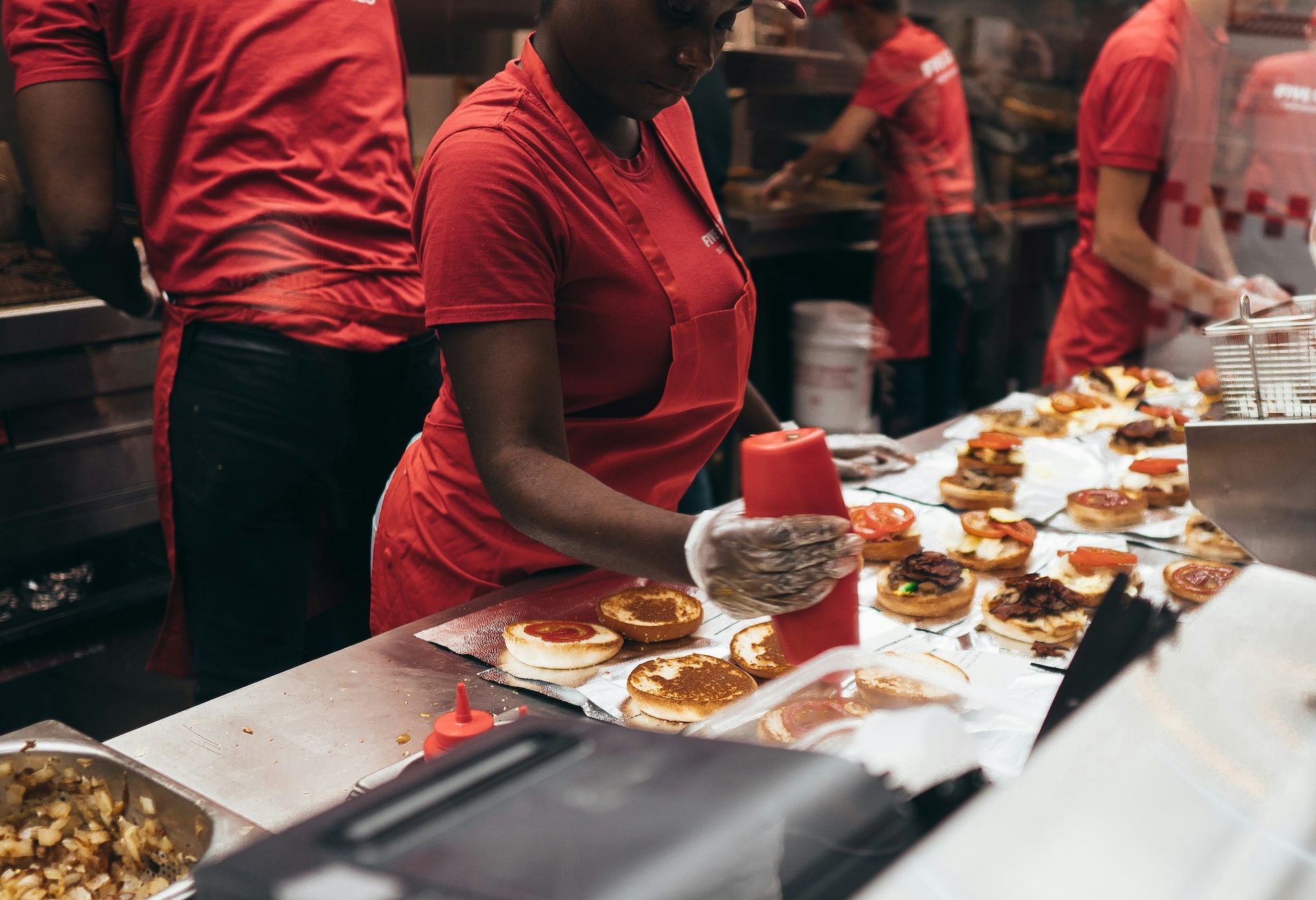 Fast food workers making burgers