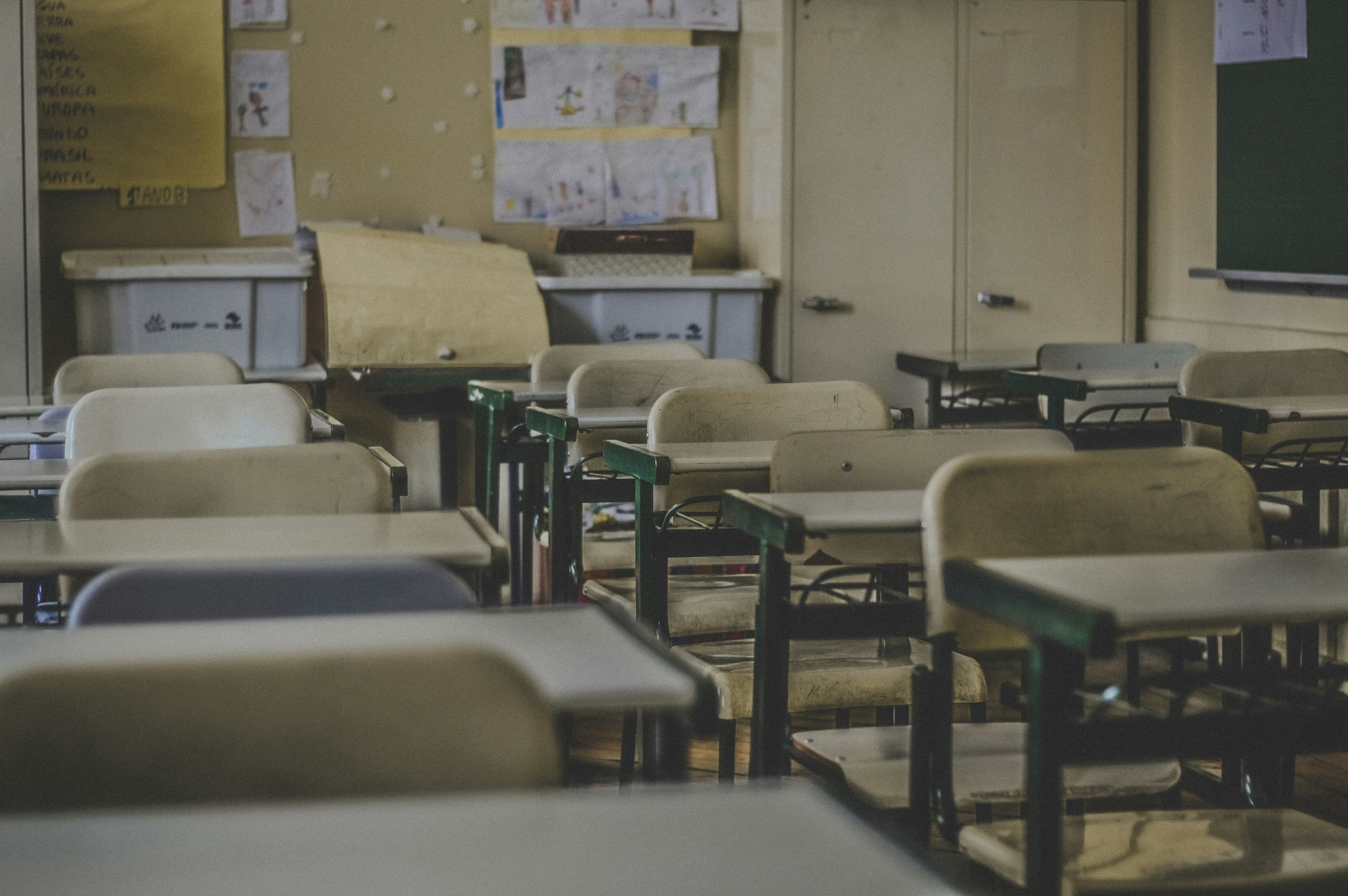 A classroom showing rows of chairs and desks for students