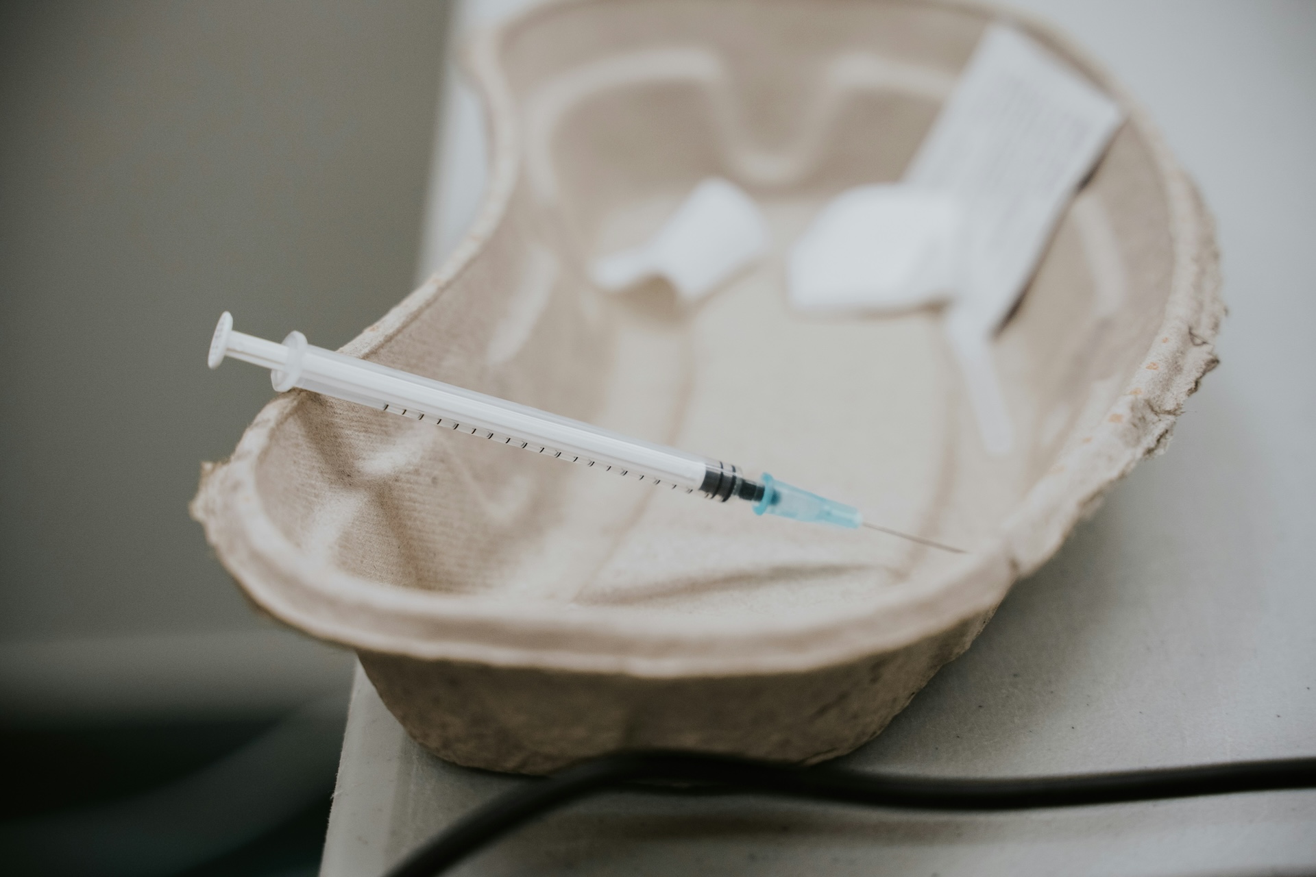Vaccination needle in a cardboard container