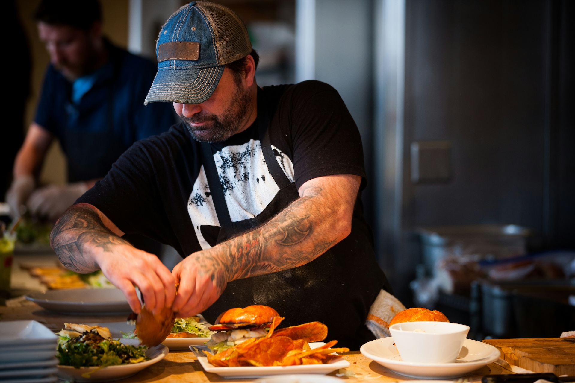 Man putting together a burger meal