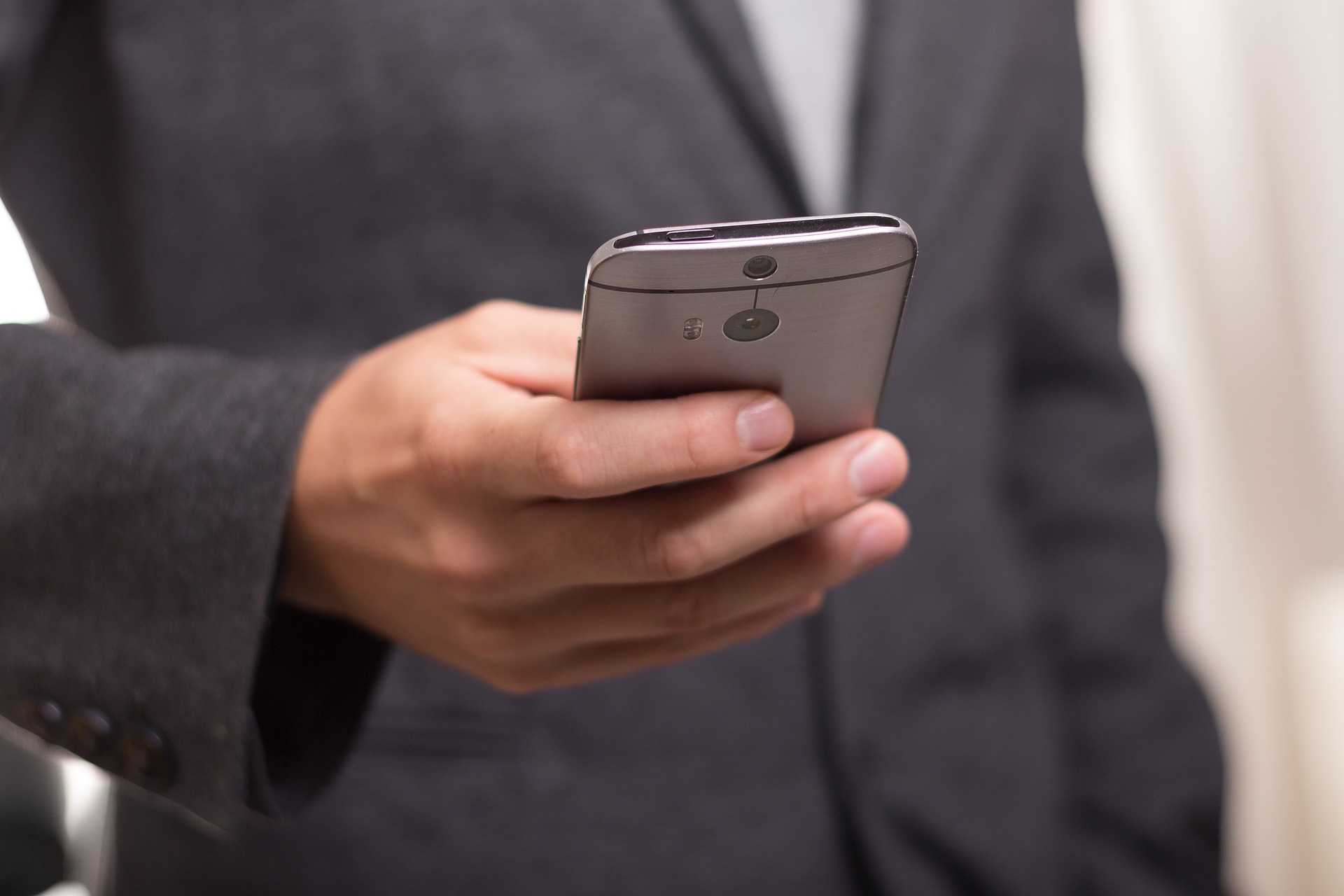 Close up of a person's hand holding a smartphone