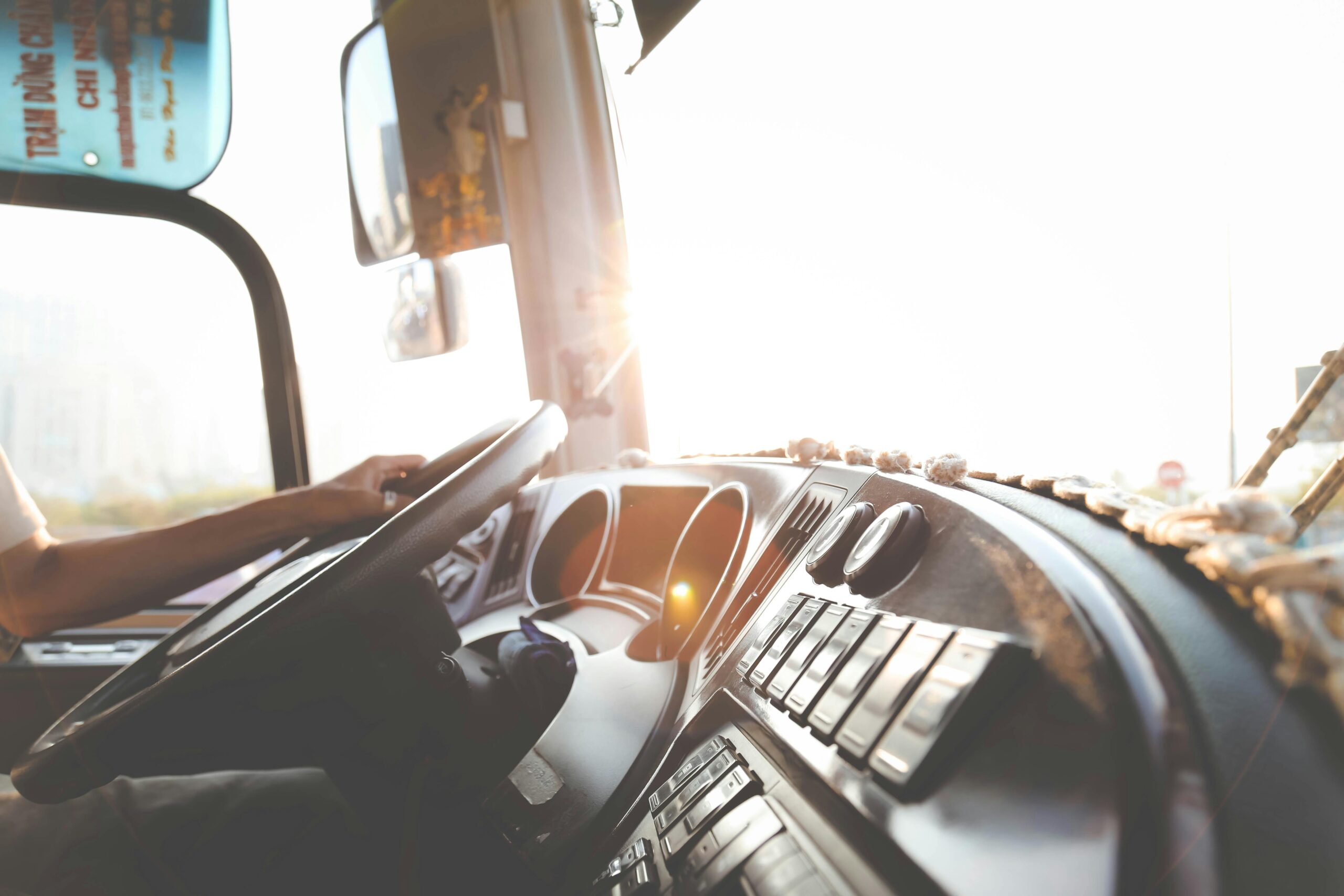 A person's hand on a steering wheel
