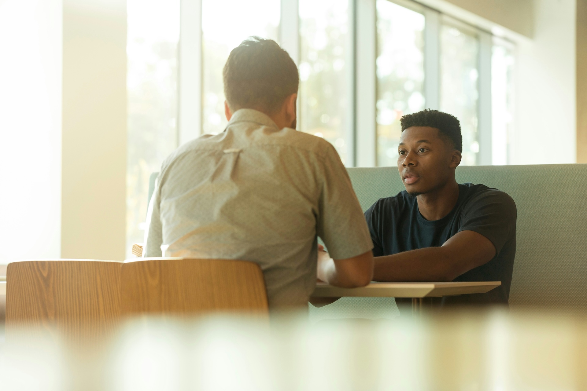 Two people having a meeting at a table.